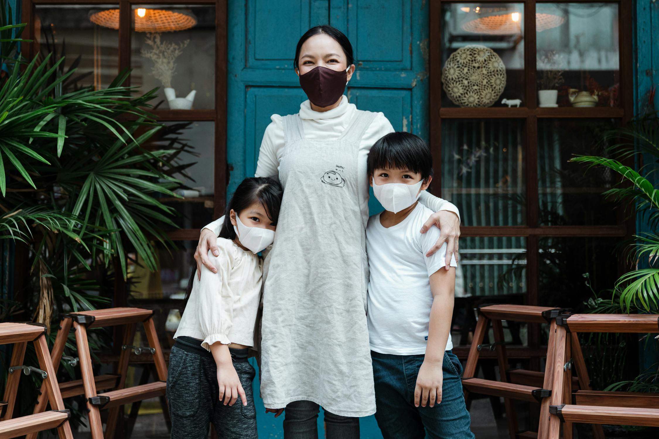 Woman and kids wearing a face covering.