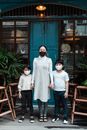 Calm woman with son and daughter in face masks