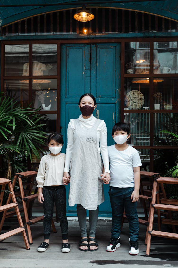Calm Woman With Son And Daughter In Face Masks