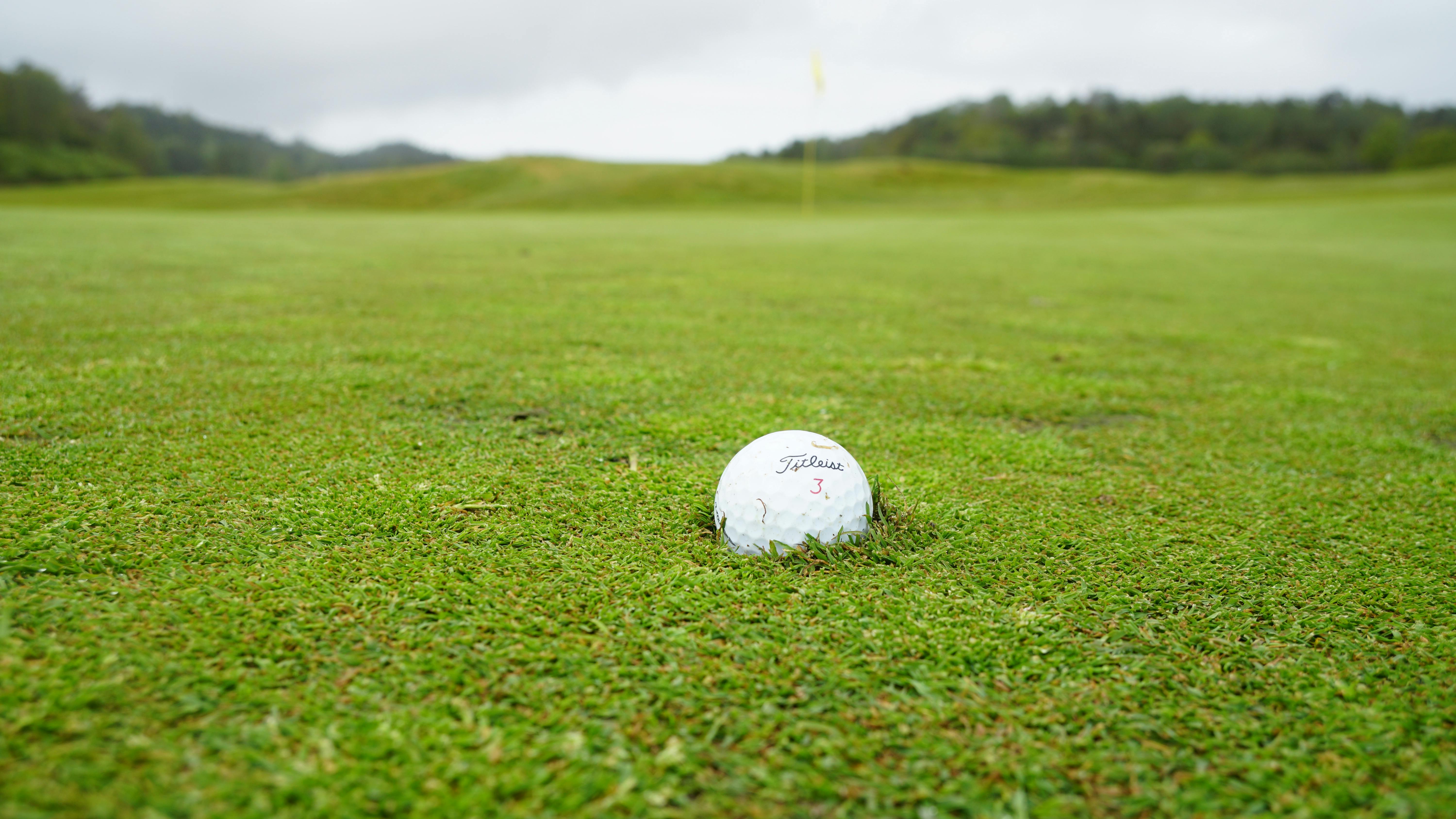 white golf ball on green grass field