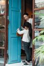 Photo of Girl Putting Wooden Sign on Doorknob