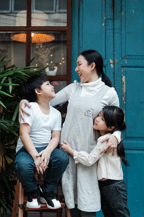 Free Photo of Woman Hugging Her Kids Stock Photo