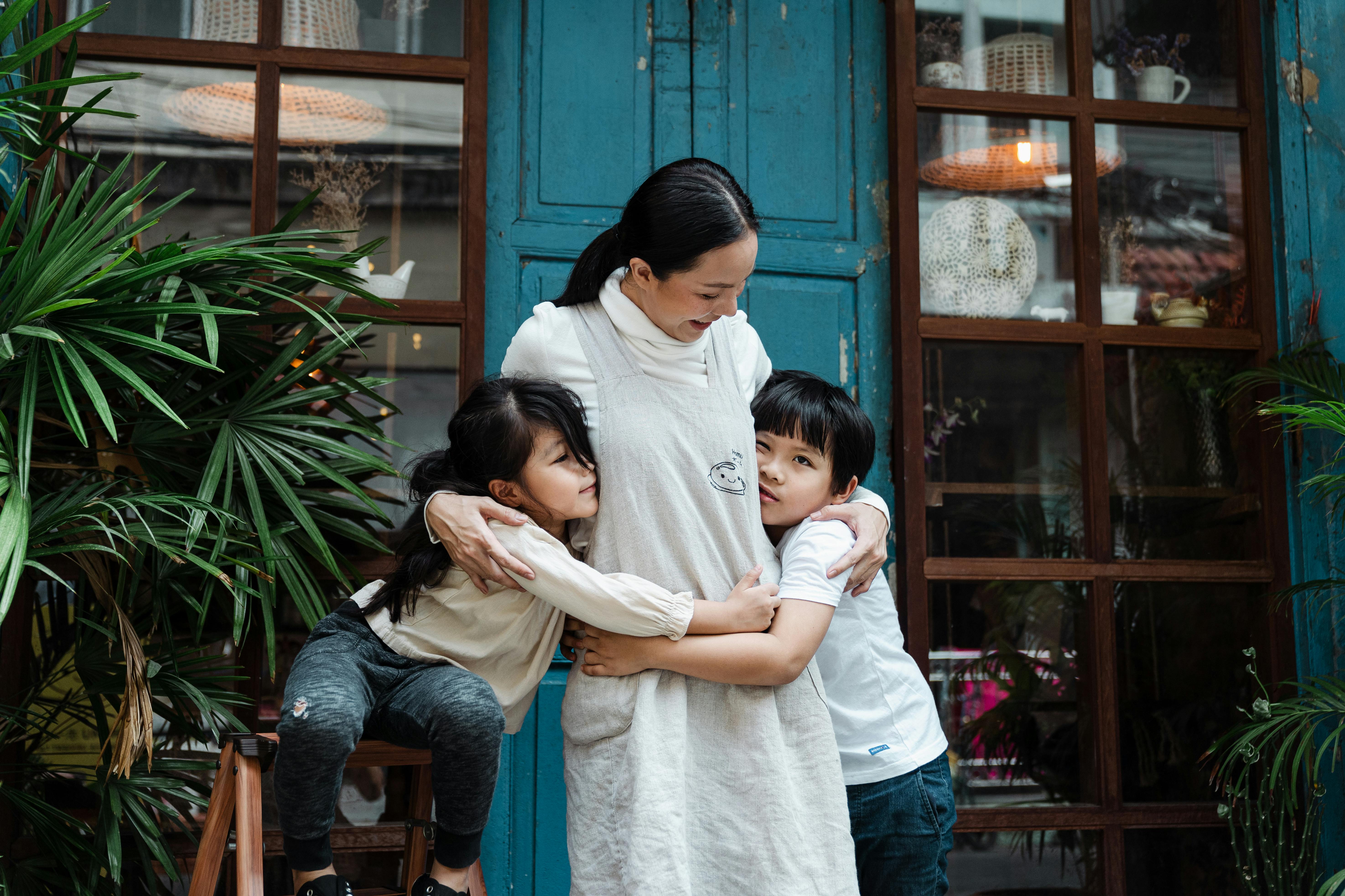 photo of woman having fun with her kids