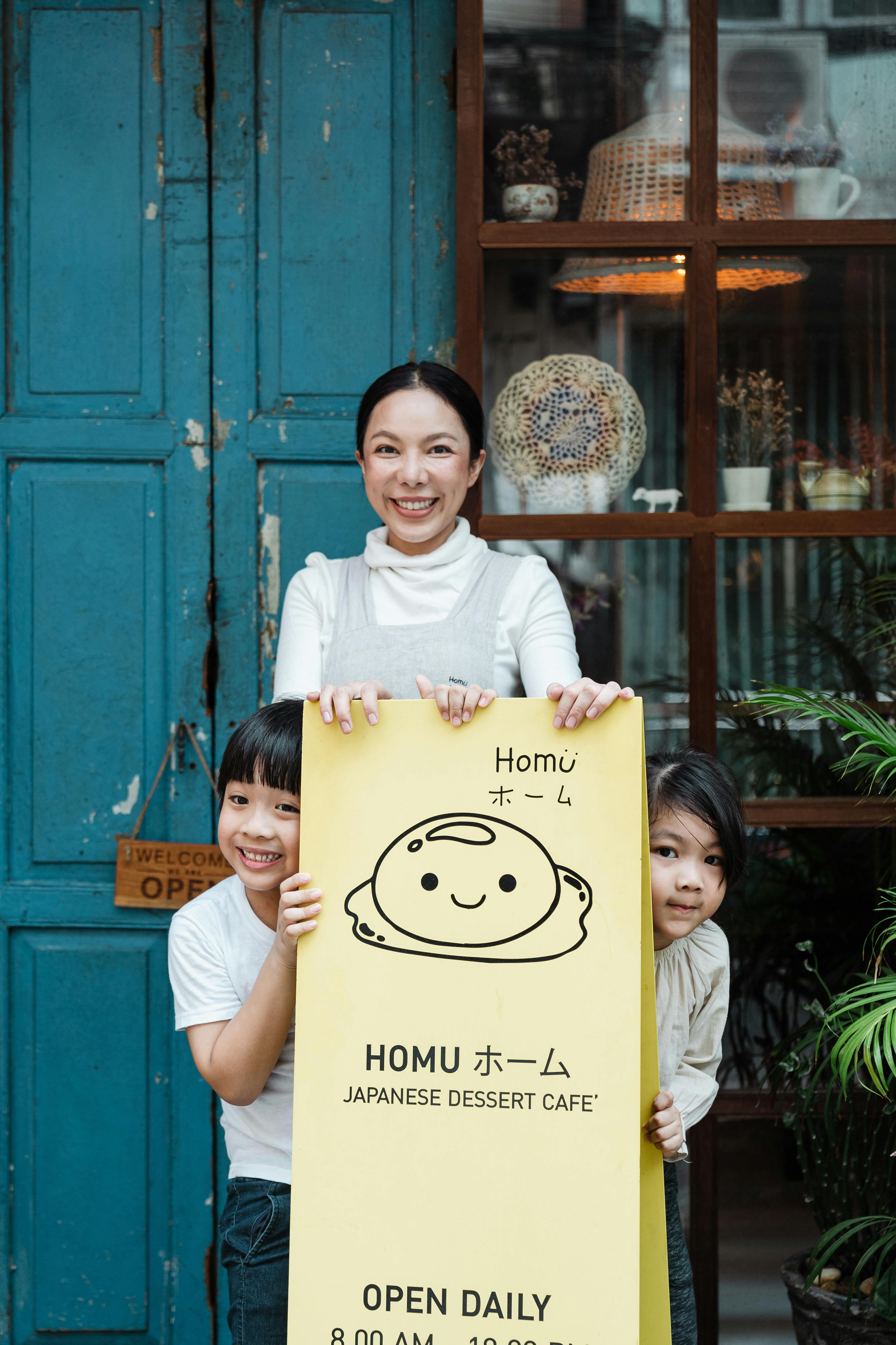 photo of family smiling while standing near signage