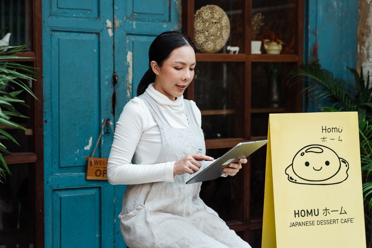 New business owner smiling at the counter of their shop