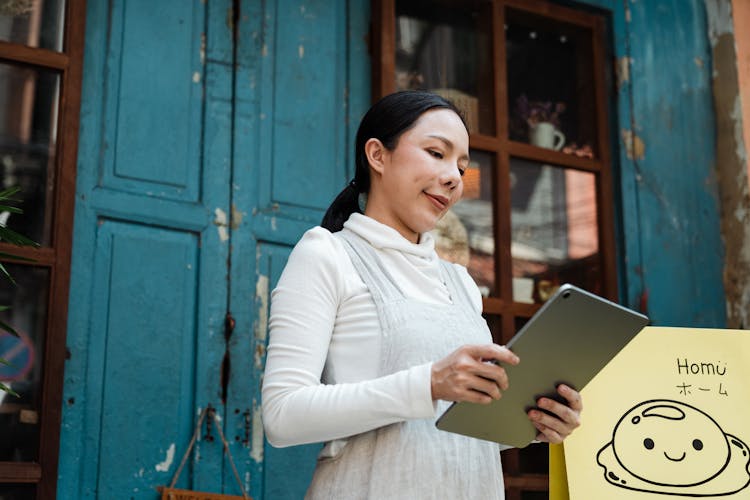 Woman Holding Silver Tablet Computer