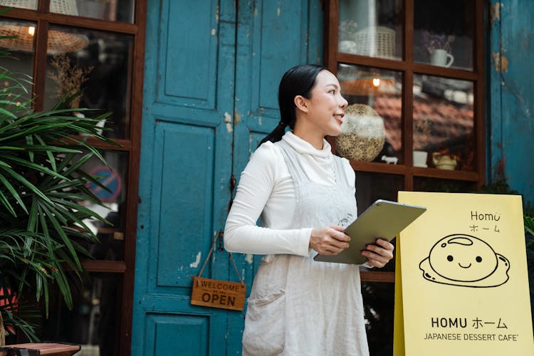 Photo Of Woman Holding Silver Tablet Computer