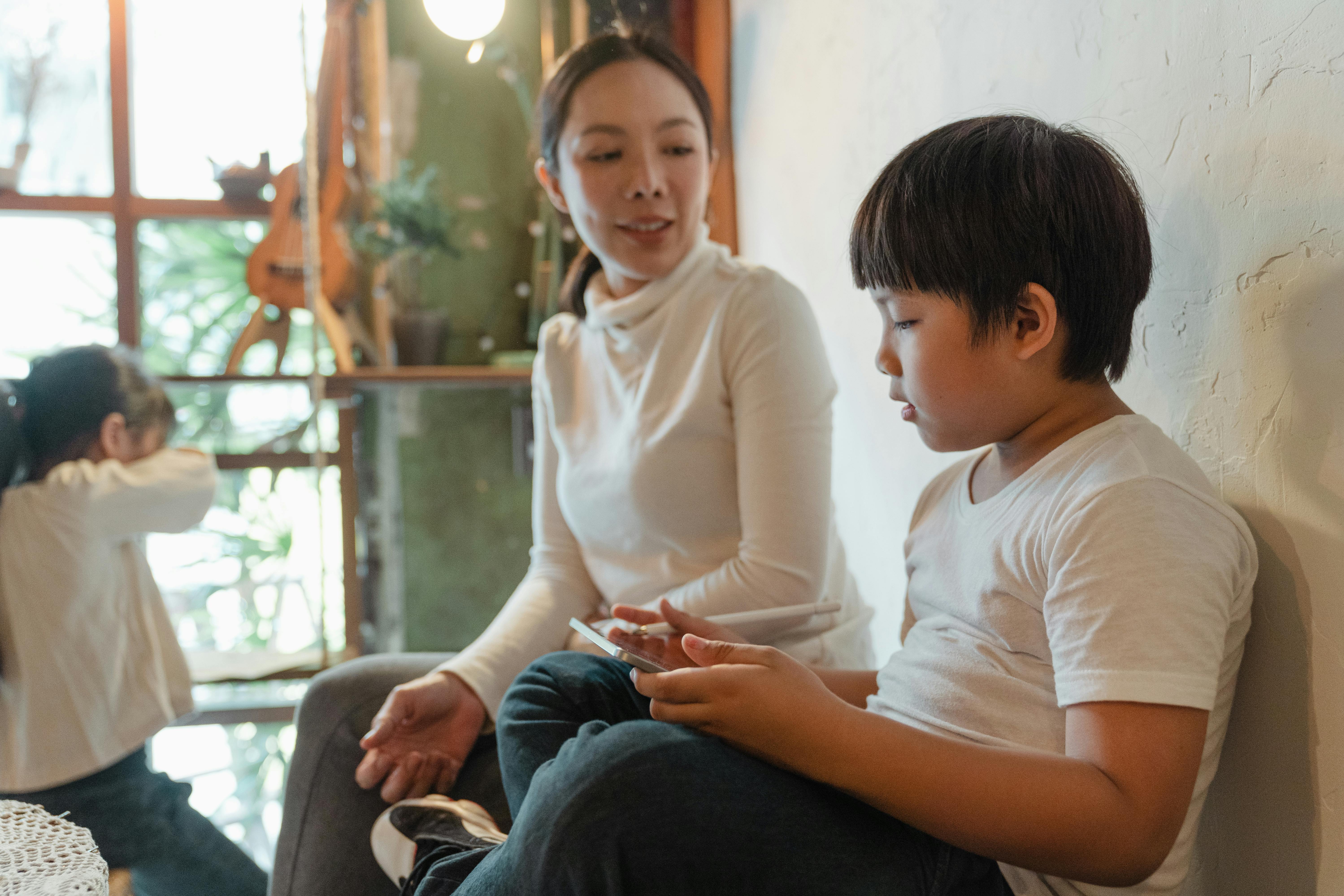adult asian mother and children spending time at home