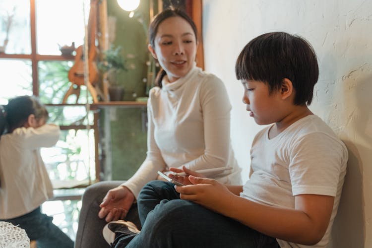 Adult Asian Mother And Children Spending Time At Home