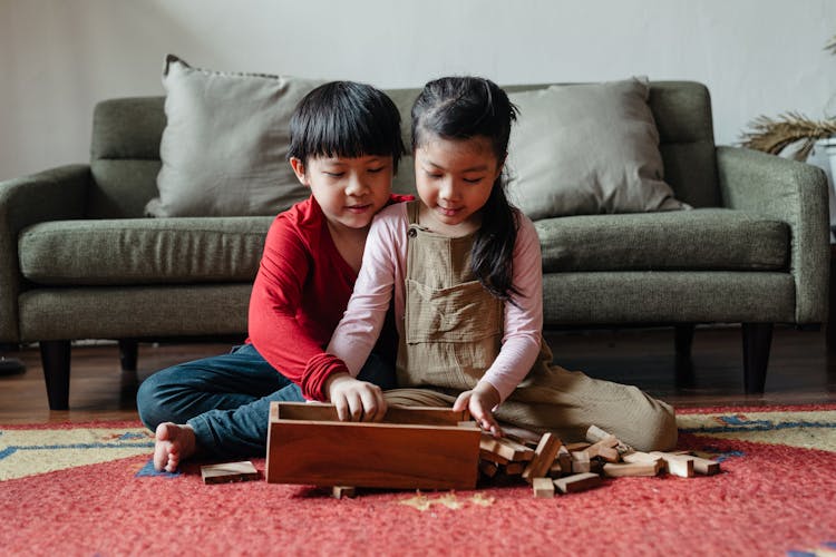 Cute Barefoot Ethnic Kids Playing Jenga At Home