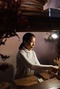 Confident Asian woman working in cozy cafeteria in evening