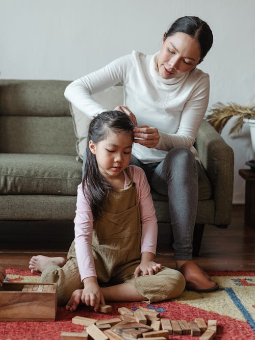 Free Photo of Woman Tying Her Daughter's Hair Stock Photo