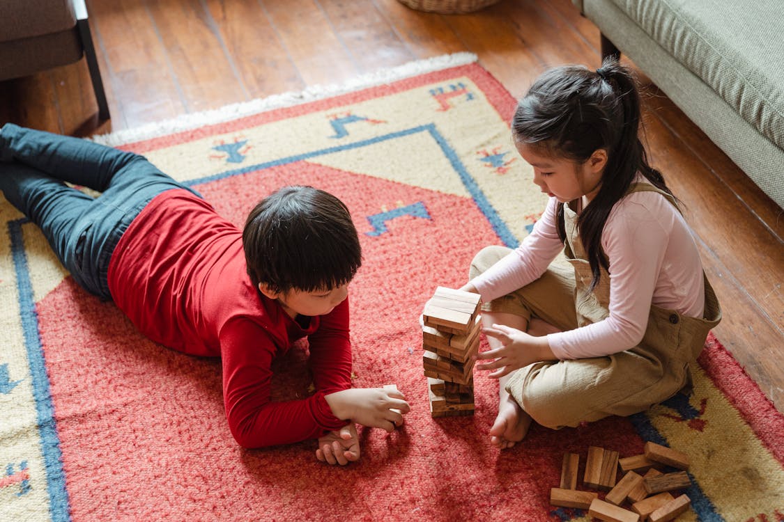 Photo of Two Kids Playing Jenga