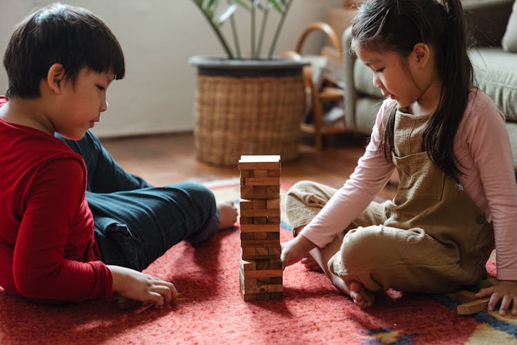 Photo Of Two Kids Playing Jenga