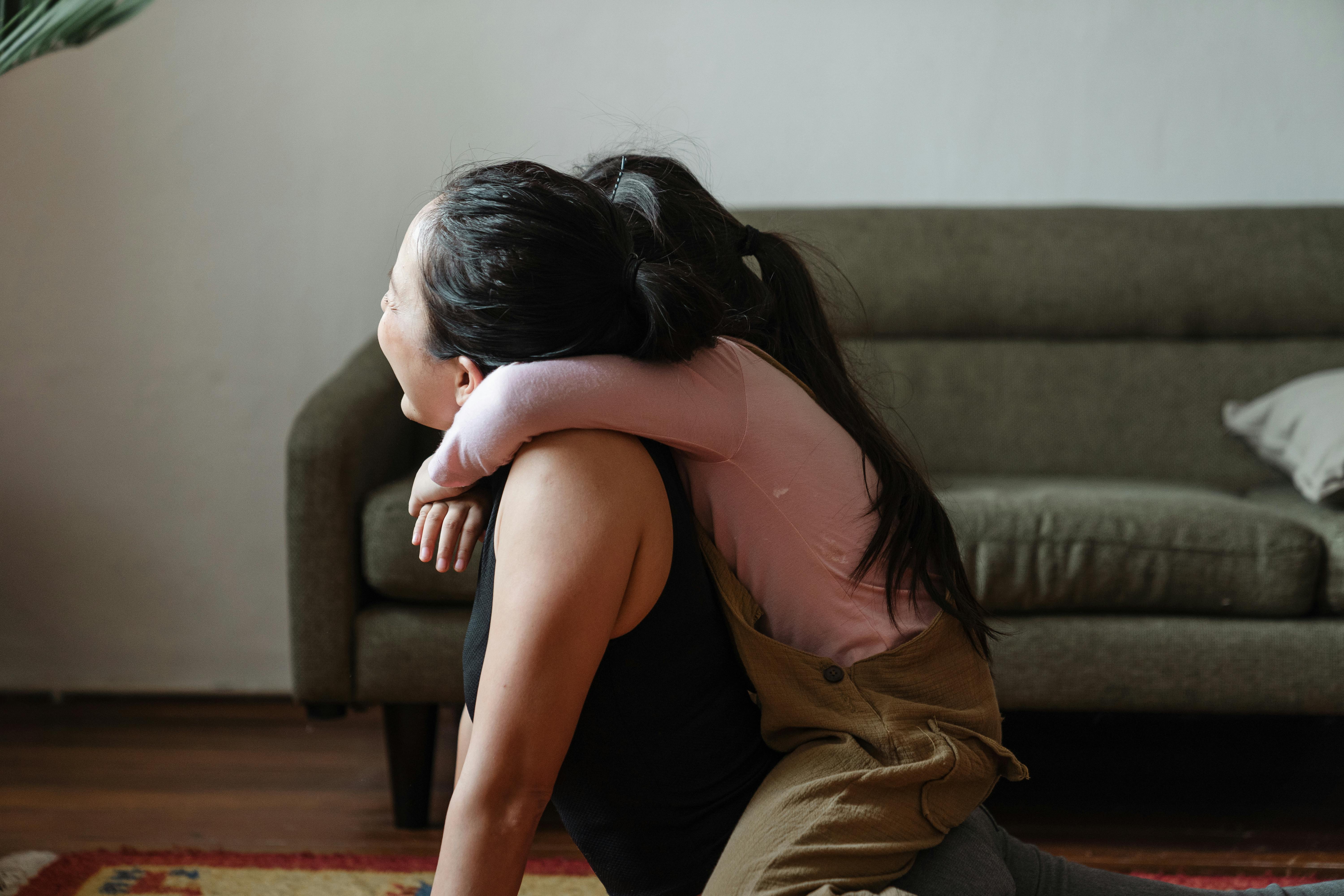 photo of girl hugging her mom