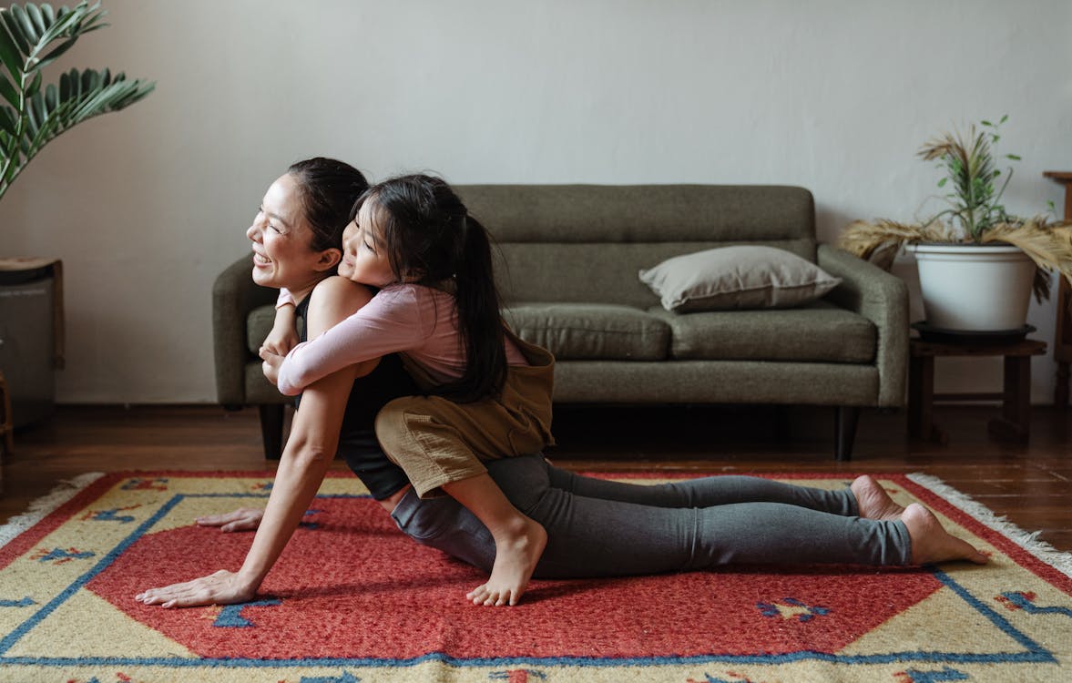 Free Photo of Girl Hugging Her Mom While Doing Yoga Pose Stock Photo