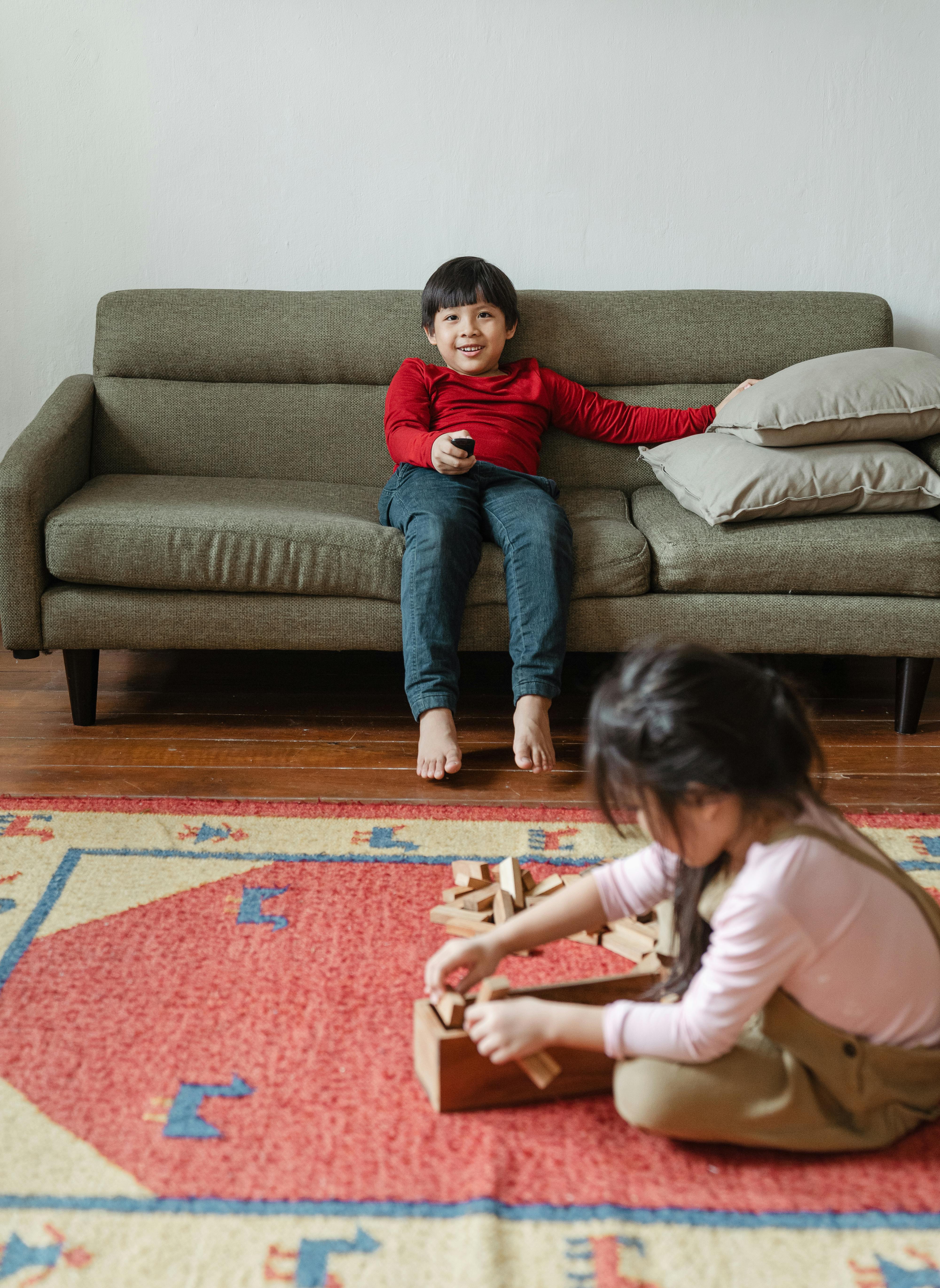 cute asian children resting at home together