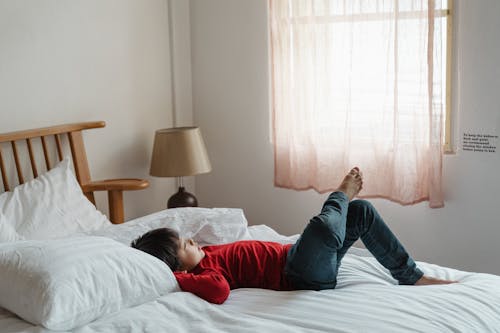 Free Photo of Boy Lying Down on Bed Stock Photo
