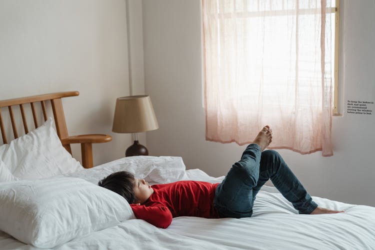 Photo Of Boy Lying Down On Bed