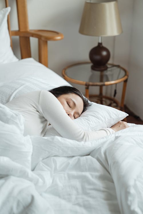 Free Young woman sleeping in comfy bed Stock Photo
