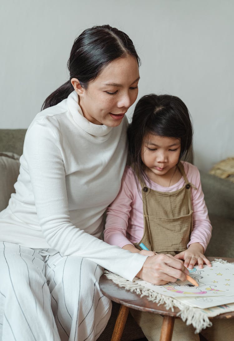 Mother And Daughter Coloring Drawings On Paper