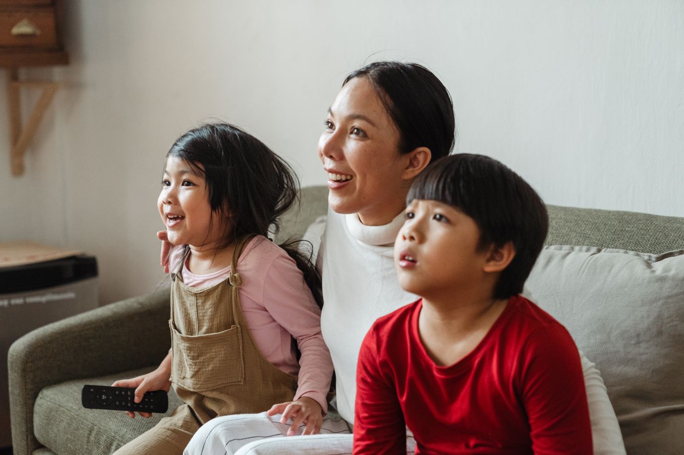 Family in a US home watching separate IPTV streams on multiple televisions simultaneously