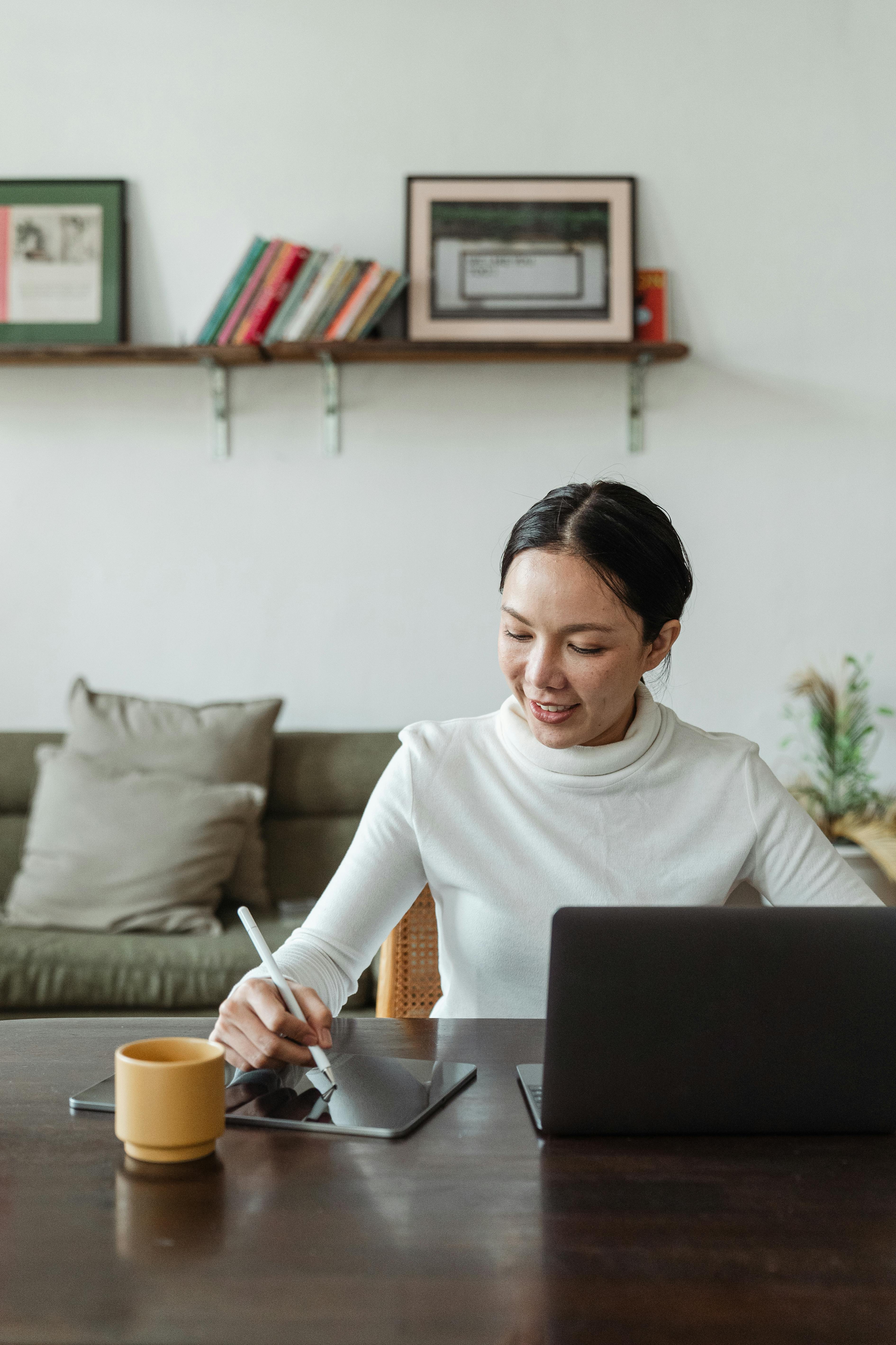 Positive japanese woman freelancer working from home, using gadgets Stock  Photo by Prostock-studio