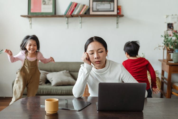 Kids Making Noise And Disturbing Mom Working At Home