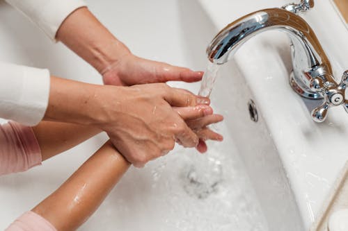Free Crop mother washing hands of child in bathroom Stock Photo