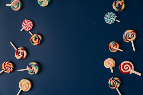 Free Colorful Lollipops on Dark Blue Background Stock Photo