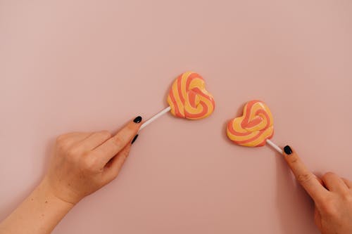 Free Person Holding Heart Shaped Lollipop Stock Photo