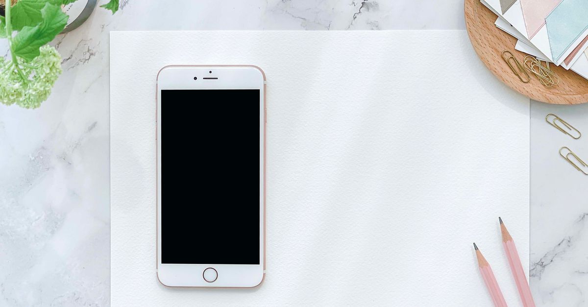person leaving smartphone in a drawer, wooden desk, morning light, minimalist aesthetic