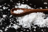 Coarse sea salt on a wooden spoon — photo by Maria Petersson on Pexels