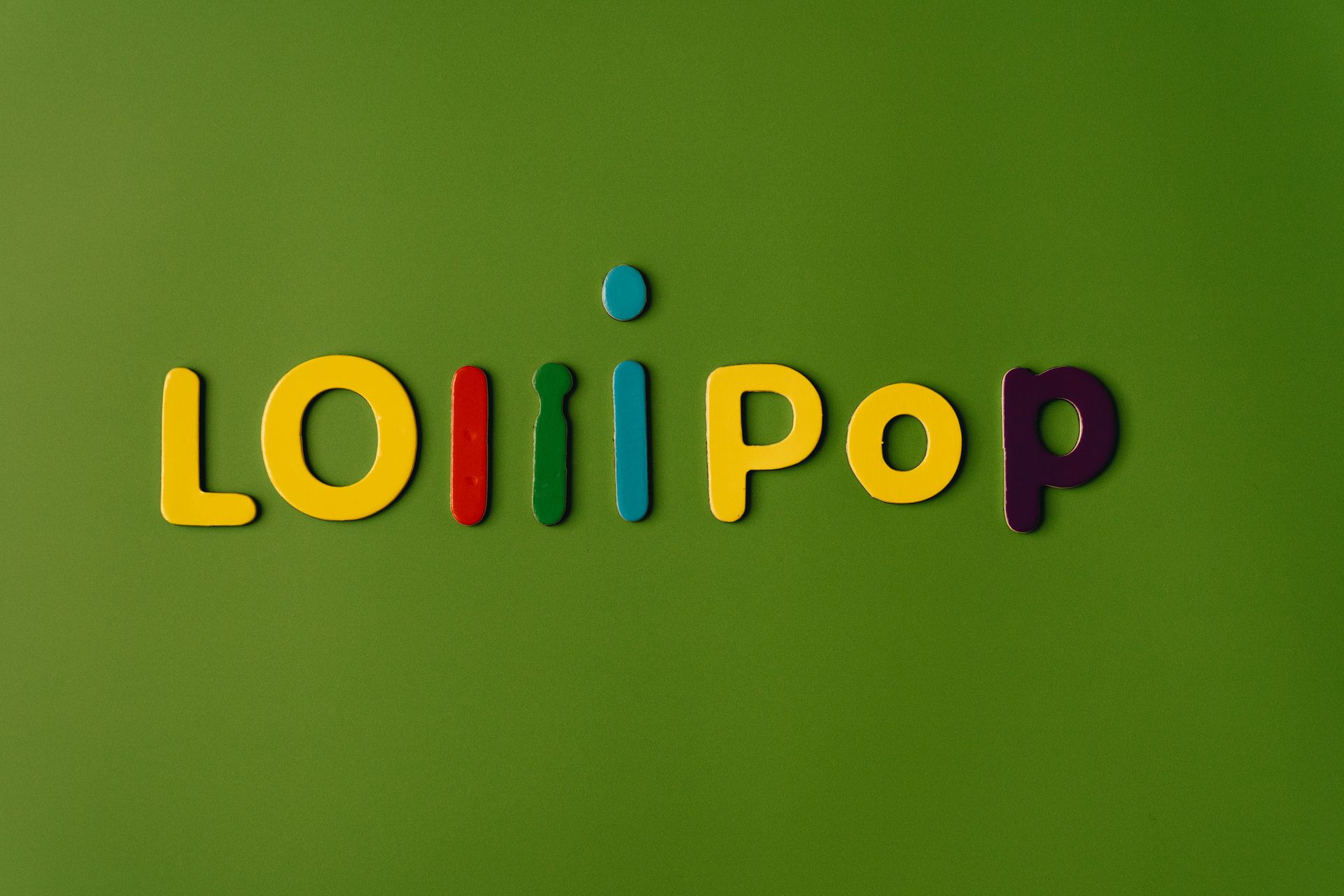 Bright and playful lollipop text in colorful letters on a green backdrop.