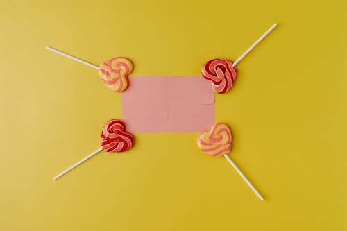 Colorful Lollipops Lying Around Pink Square 