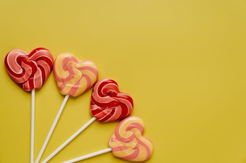 Colorful Lollipops on Yellow Background 