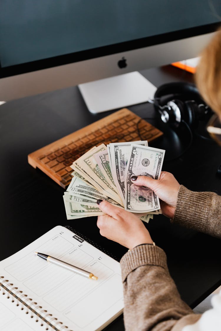 A Person Counting Her Money