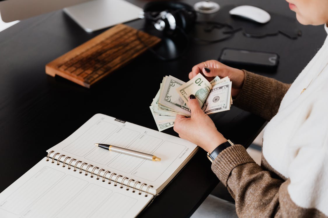 Crop entrepreneur counting money in office