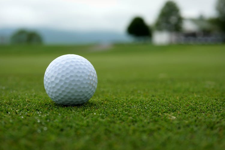 White Golf Ball On Green Grass Field