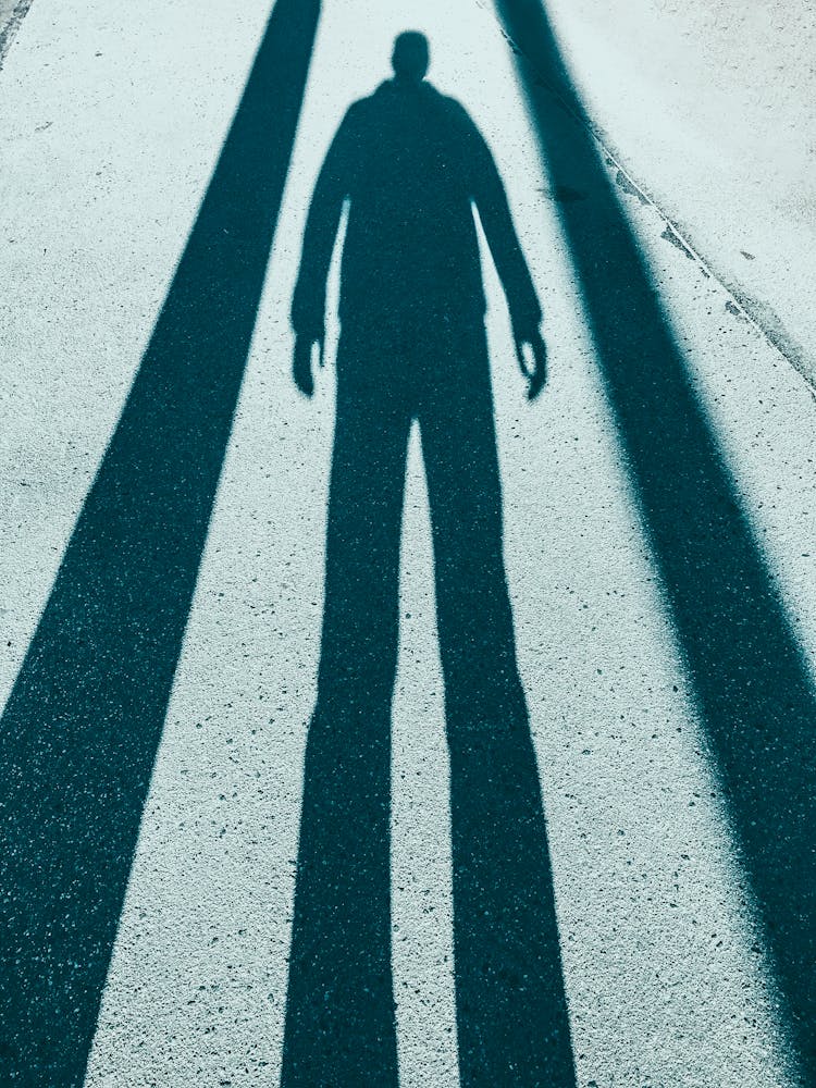 Shadow Of Anonymous Man On Street