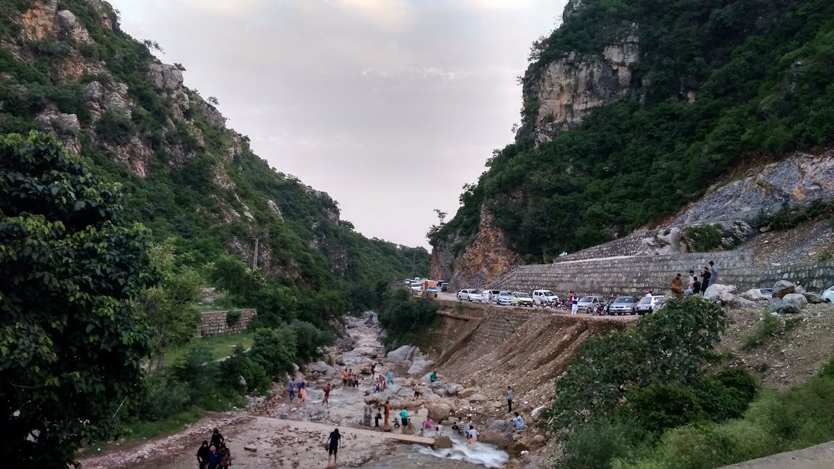 Parent applying mosquito repellent to a child's arm outdoors