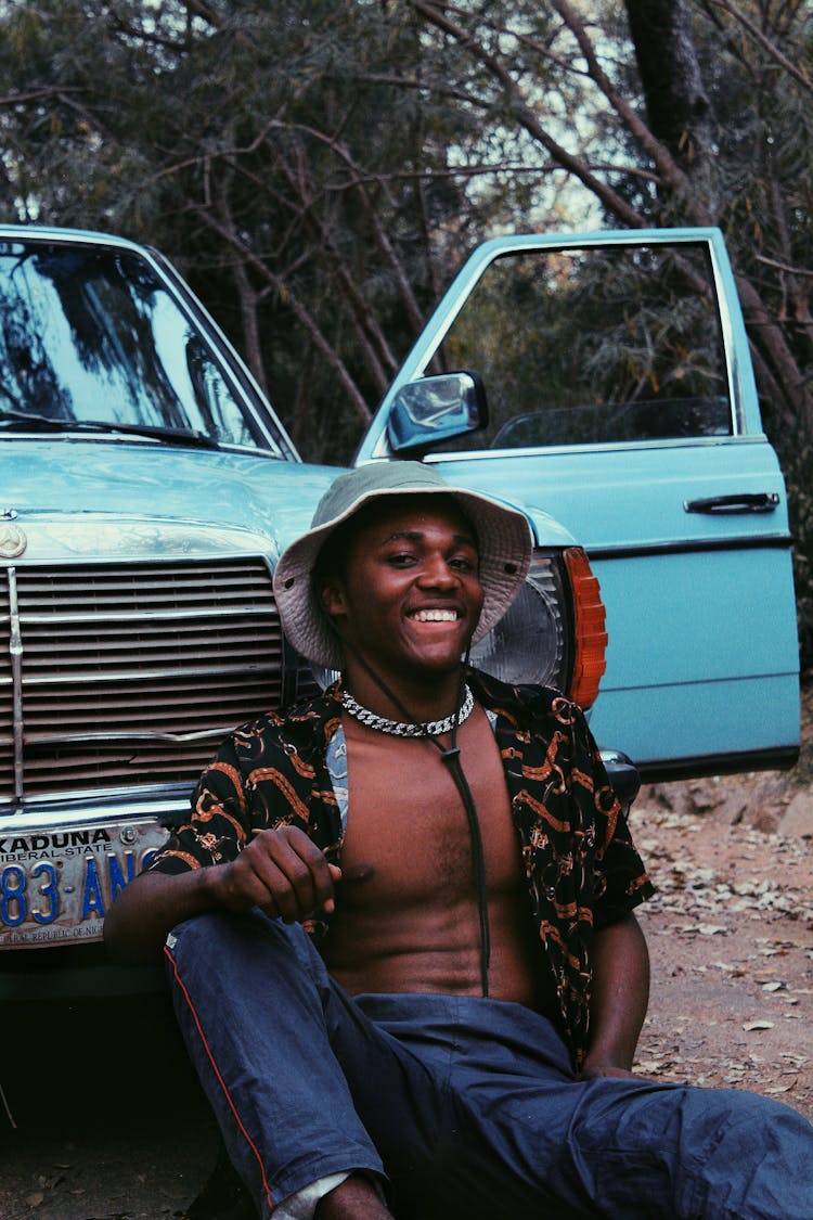 Positive Black Man Near Car In Park