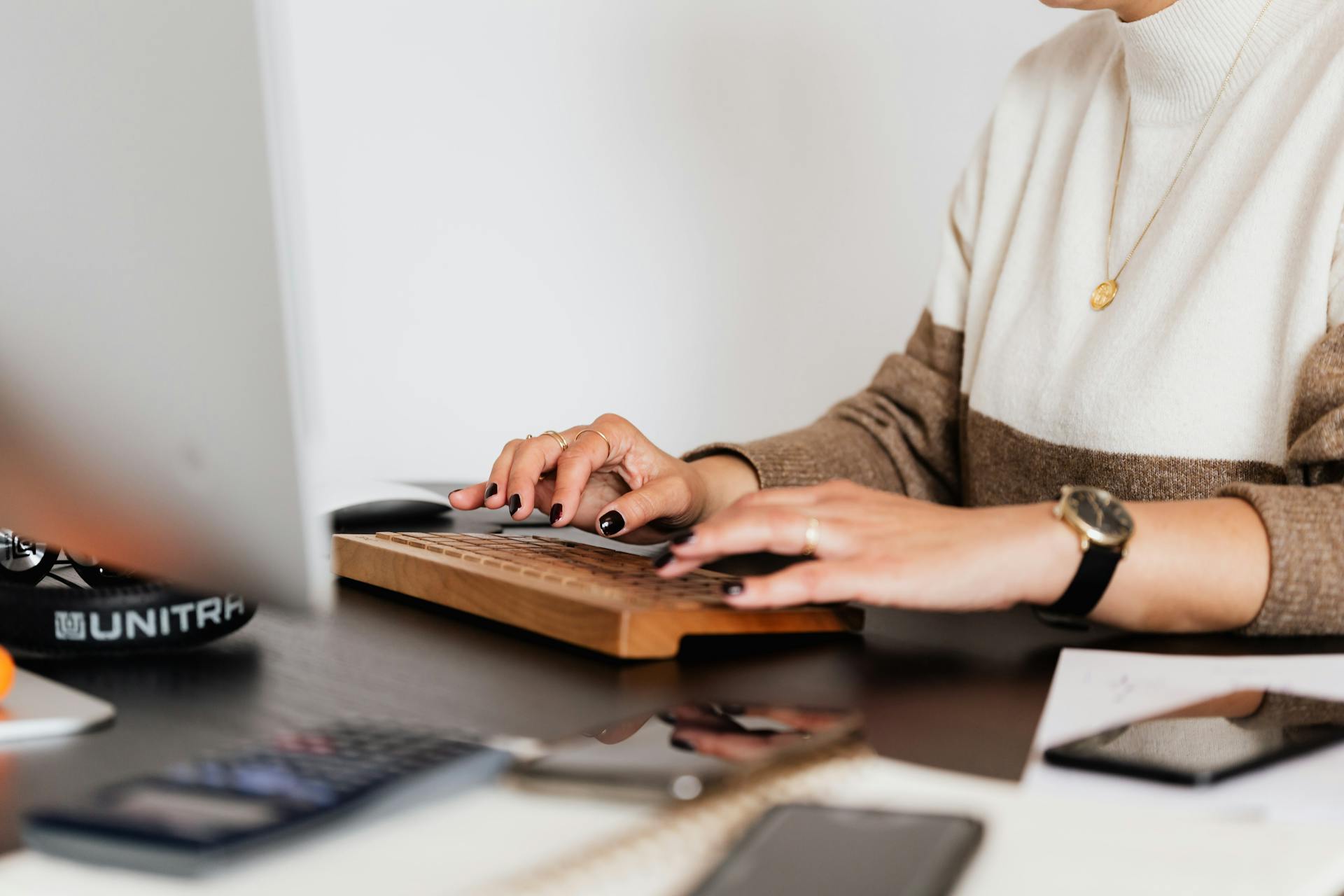 Crop woman typing on creative computer keyboard