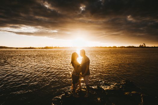 Loving couple at seaside at sunset