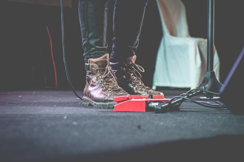 Free Person Standing Beside Guitar Effect Pedals Stock Photo