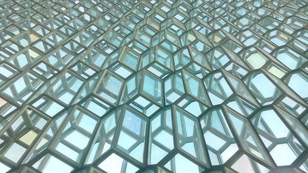 Intricate geometric pattern of Harpa Concert Hall's glass facade in Reykjavik, Iceland.