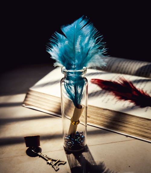 Free Feather in glass bottle on table Stock Photo