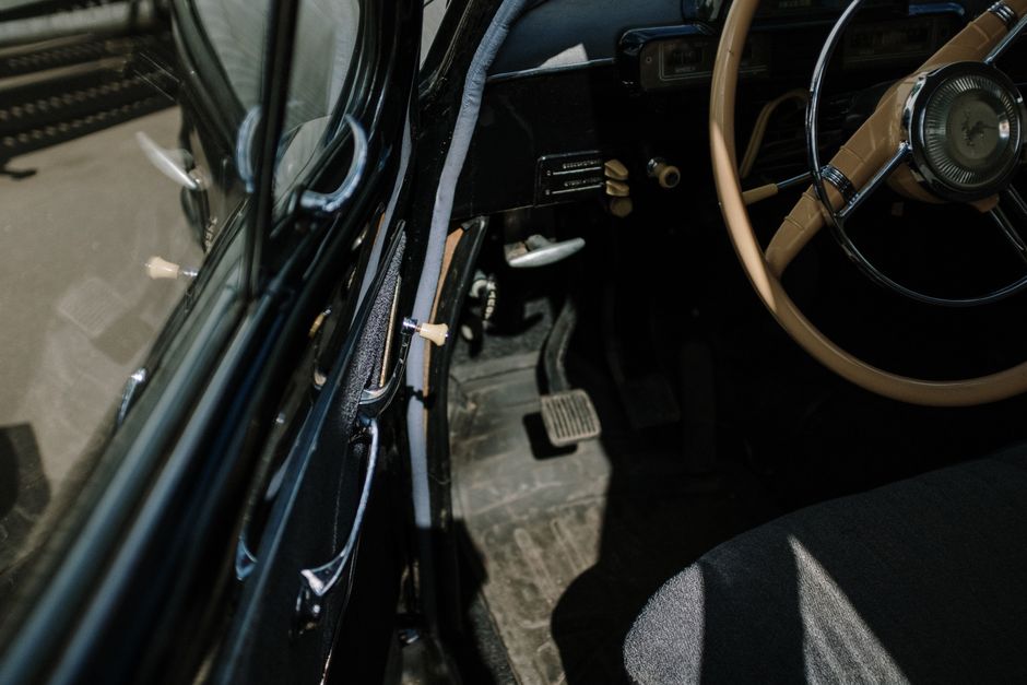 worn car pedals and steering wheel closeup