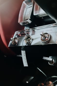 Close-up of a classic car dashboard with vintage controls and chrome accents.
