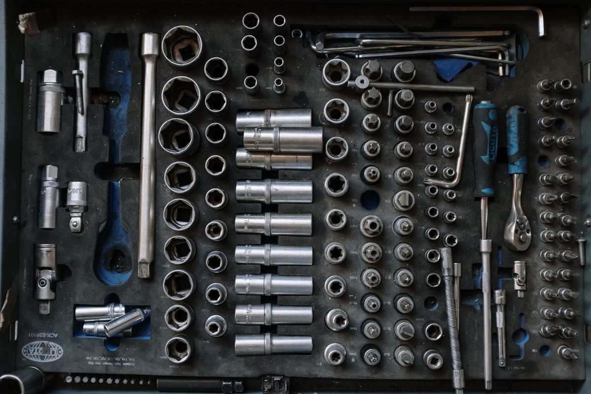 Organized impact socket set with metric and SAE sizes laid out flat for garage use